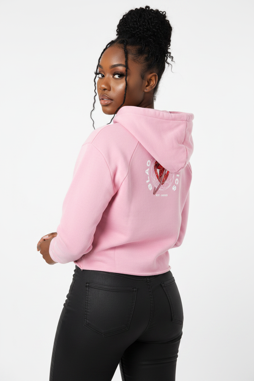 Person wearing a pink hoodie with a heart design on the back, standing against a white background