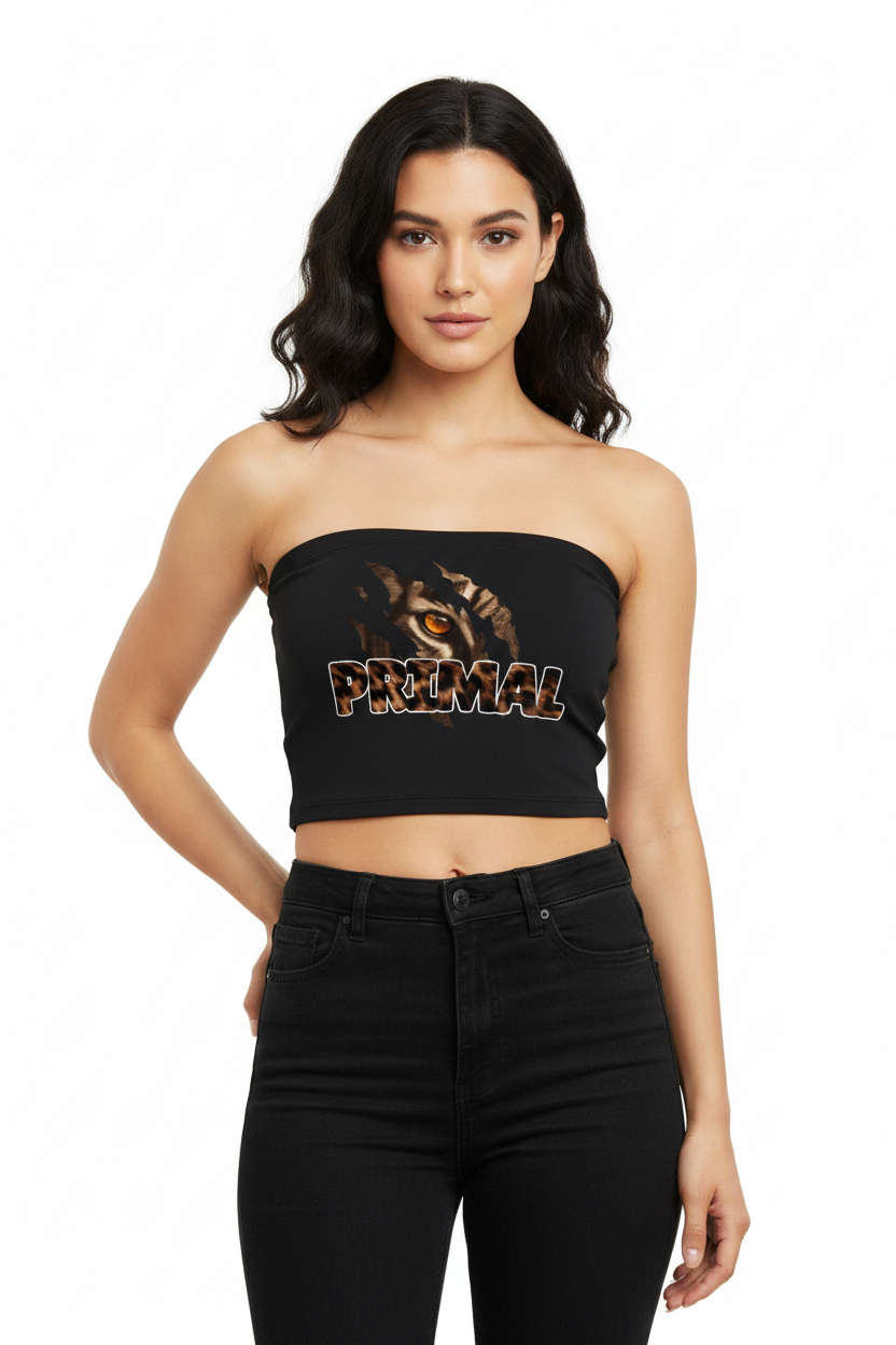 A woman modeling a black strapless crop top with a tiger graphic and the word 'PRIMAL' across the front, paired with black jeans against a plain white background.